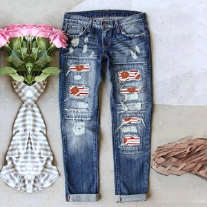 High-waist ripped blue denim jeans with American football themed patchwork on the legs