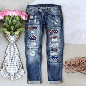Slim fit dark blue ripped jeans with American football and stars patches on gray ground