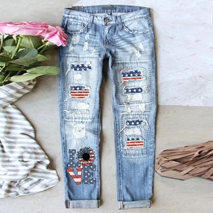 Light blue straight jeans with distressed American flag patches and floral LOVE prints