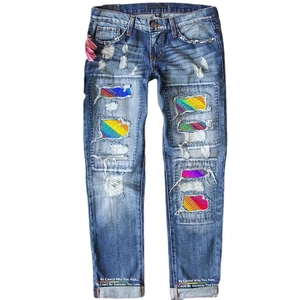 Mid-waist ripped jeans for women with rainbow patchwork and floral print accents