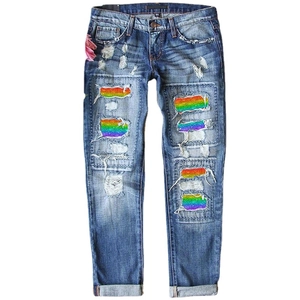 Women's blue washed straight denim pants with rainbow glitter patches and ripped detail