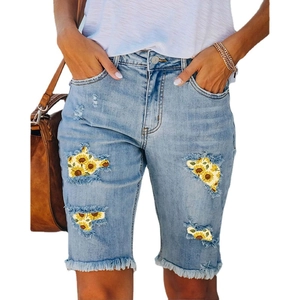 Light blue ripped denim shorts with sunflower print lining and raw hems for summer wear
