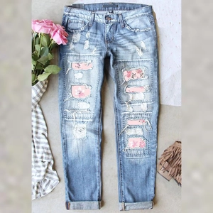 Light blue ripped jeans with floral patches, distressed mid-rise straight denim for women