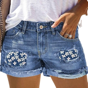 Women's blue denim shorts with floral patch distressed holes and frayed hem style