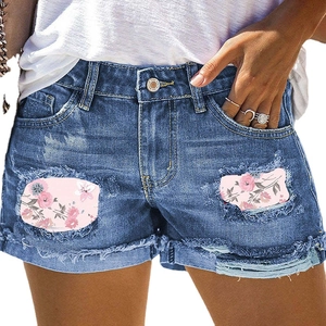 Vintage blue denim shorts with floral print patchwork ripped details and raw hem