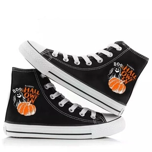 Detail of Halloween high-top canvas shoes with pumpkin, ghost prints and BOO lettering