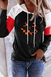 Detail of color-block Halloween hoodie featuring a pumpkin print and drawstring hood