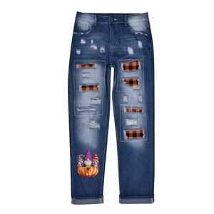 Distressed dark blue denim jeans with Halloween pumpkin print and plaid lining details