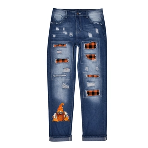 Blue washed denim jeans with distressed holes, orange plaid lining, and festive gnome print