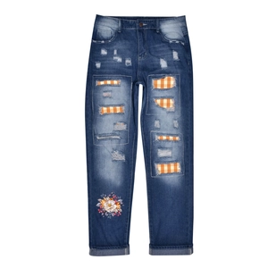 Deep blue washed jeans with orange plaid patches, flower embroidery and ripped details