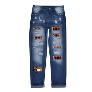 Relaxed blue wash jeans with distressed holes, plaid lining and pumpkin holiday prints