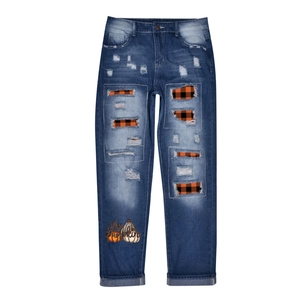 Distressed blue jeans with orange plaid lining and Hey Pumpkin printed graphics