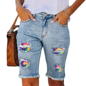 Women high waisted distressed denim shorts with colorful tie-dye lining and frayed edges