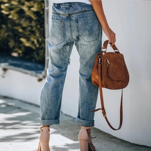 Rear view of sunflower print jeans showing the fit, back pockets, and faded wash detail