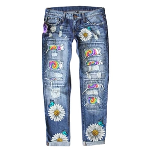 Women's high waist ripped jeans with colorful tie-dye patches and daisy floral prints