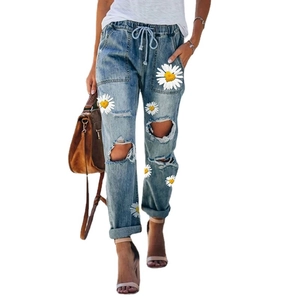Women's light blue sunflower print ripped jeans with drawstring waist and loose fit