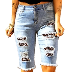 Women's light blue high waist denim shorts with leopard print patches and frayed hems
