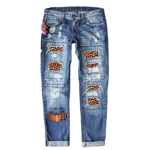 Women's dark blue wide leg jeans with leopard print patches and festive pumpkin print