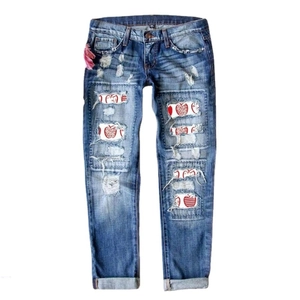 Women's blue straight-leg denim jeans featuring distressed apple patches and leopard prints