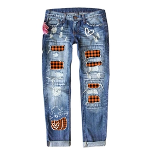 Women's dark blue distressed jeans with Halloween pumpkin and witch hat patches