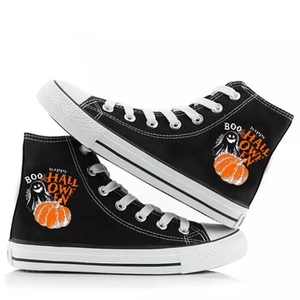 Detail of Halloween ghost and pumpkin print on black high-top canvas sneakers