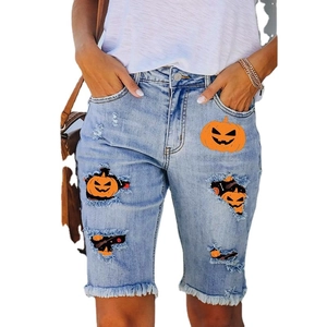 Women's light blue Halloween denim shorts with pumpkin patches and frayed edges