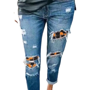 Women slim fit ripped denim jeans featuring Halloween pumpkin and black cat patches