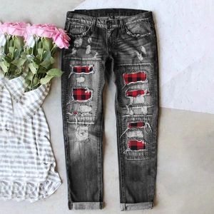 Women's blue washed distressed jeans with vintage red plaid patches and ripped detailing