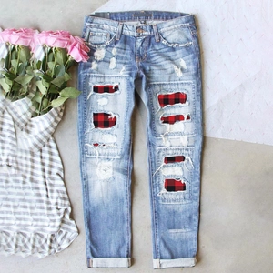 Women's mid-waist blue ripped slim jeans with red plaid patches and distressed finish