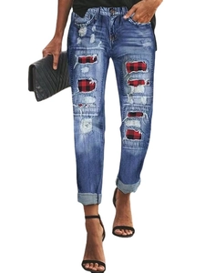 Women's blue mid-waist ripped jeans featuring red plaid patches and casual rolled hems