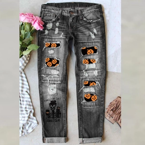 Women's distressed black jeans with Halloween pumpkin patches and skull graphic print