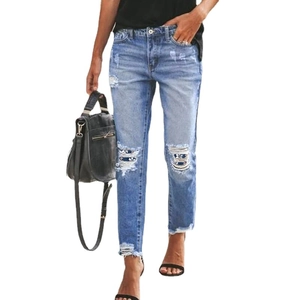 Women's light blue straight jeans with distressed ripped knees and floral fabric lining