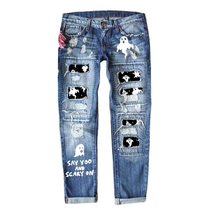 Blue distressed jeans with pink leopard patches and spooky Halloween ghost print design