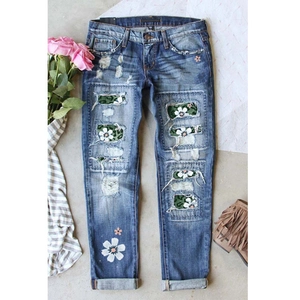 Women's slim blue ripped jeans with camouflage patches and daisy embroidery accents