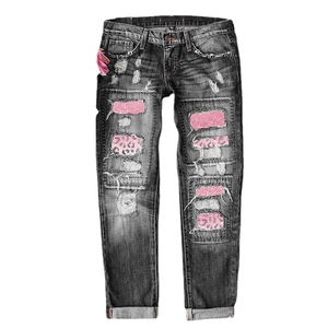 Distressed grey jeans featuring pink leopard print patches and sequins with ripped details