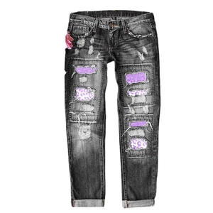 Slim fit flared denim jeans for women with purple leopard print patches and ripped details