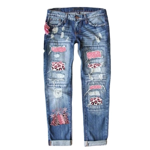 Women's blue ripped jeans with pink leopard Christmas tree patches and sequin details