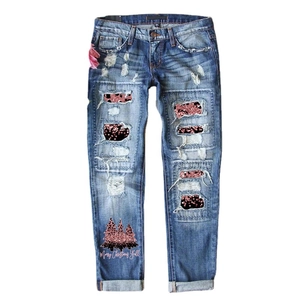 Women's blue washed ripped jeans with sequin leopard patches and Christmas tree print