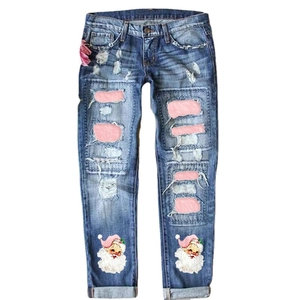 Women's blue distressed jeans with Christmas Santa Claus prints and pink knee patches
