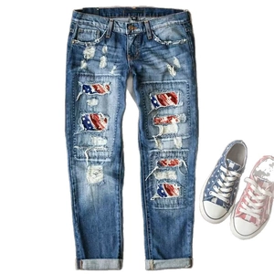 Women's blue ripped jeans with star and flag pattern patches and matching canvas shoes