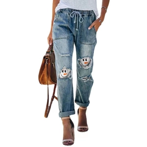 Women's light blue distressed straight jeans with festive snowman patchwork and drawstring