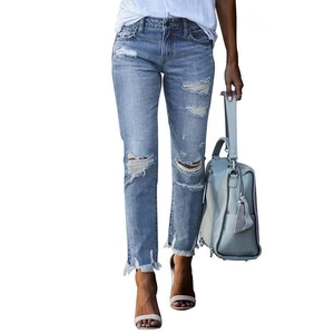 Slim fit light blue distressed jeans for women with ripped knees and frayed hem details