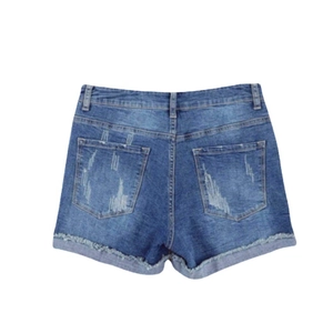 Back view of blue denim shorts with distressed back pockets and raw rolled edges