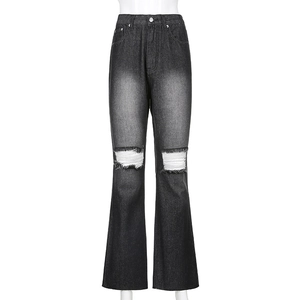 Close-up of distressed knee rips with white fringe detail on high waist flared jeans