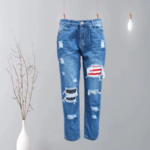Women's straight blue jeans with ripped American flag star and stripes pattern patches