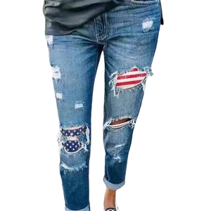 Women's blue straight leg ripped jeans with American flag patterns on a white background