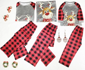 Family Christmas pajamas set with reindeer print and red buffalo plaid pants on white background
