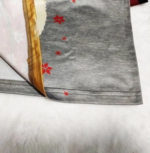 Close-up of red star print on grey knit fabric with gold lining and detailed stitching