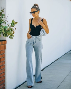 Women's high waist flared jeans with side slits and black ribbed button-front tank top