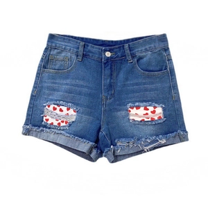 Deep blue denim shorts with heart patch distressed details and frayed edges